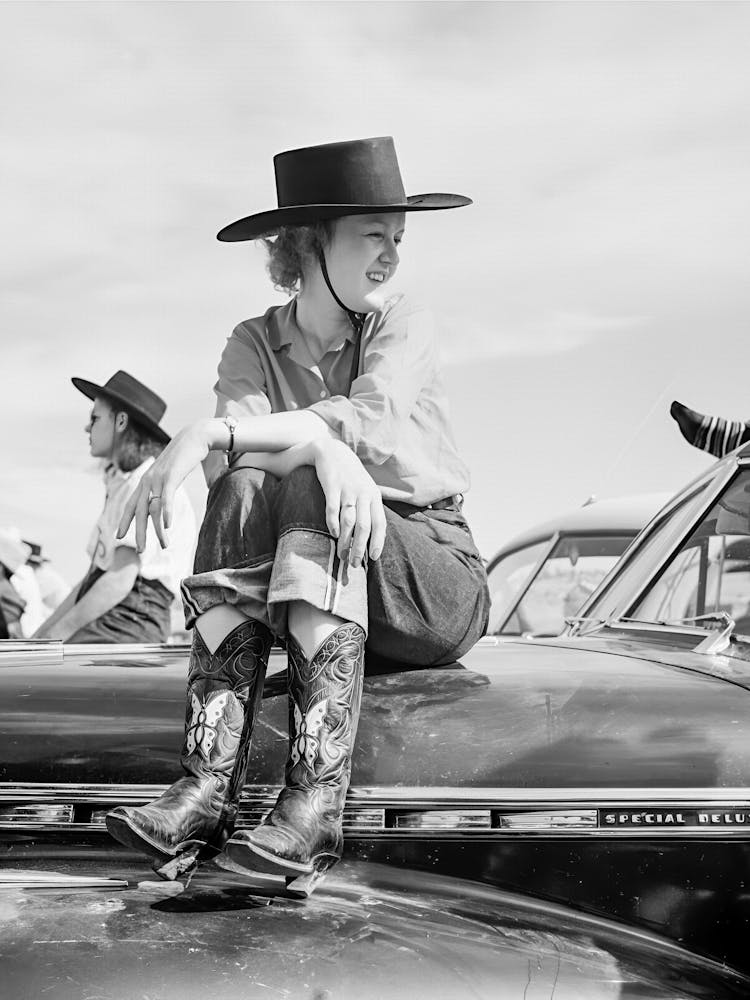 Cowgirl Sitting On Car Hood, Western Aesthetic, Vintage Black and White Old Photo
