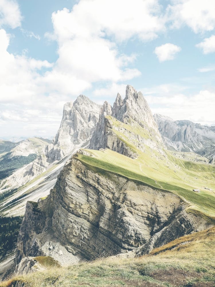 Dolomites, Italy I Seceda peaks with their sharp ridges in a majestic natural mountain landscape photography with its green valleys under pastel cloudy summer skies for a spectacular skyline panorama view