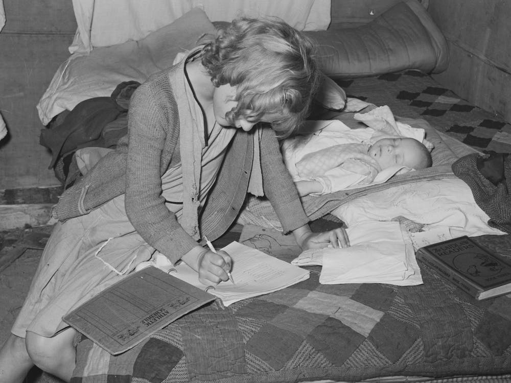 Daughter Of Migrant Auto Wrecker Doing Her Lessons On Bed In Tent Home, Corpus Christi, Texas By Russell Lee