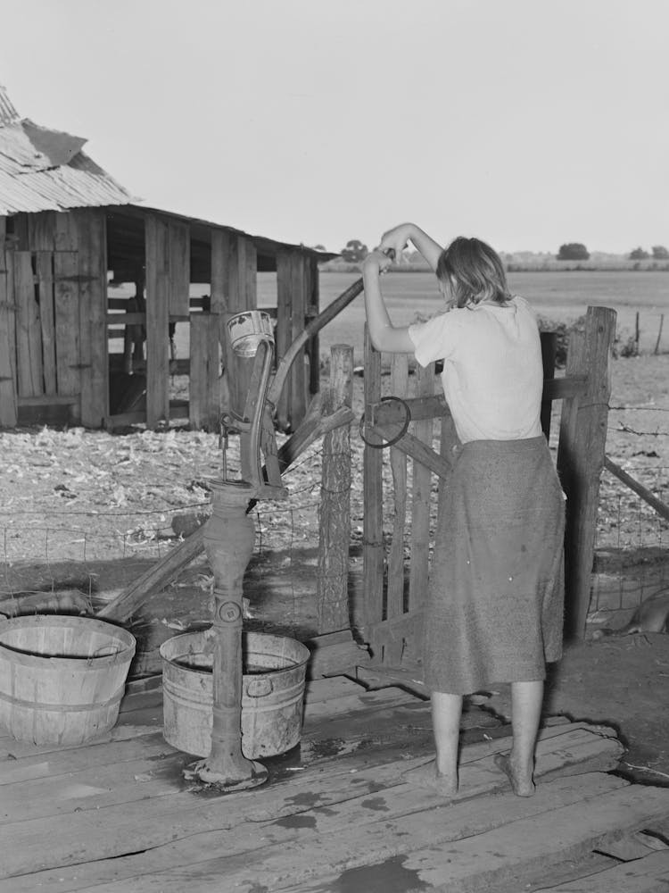 Daughter Of Tenant Farmer Living Near Muskogee, Oklahoma, Pumping Water Out Of Tub,See General Caption Number