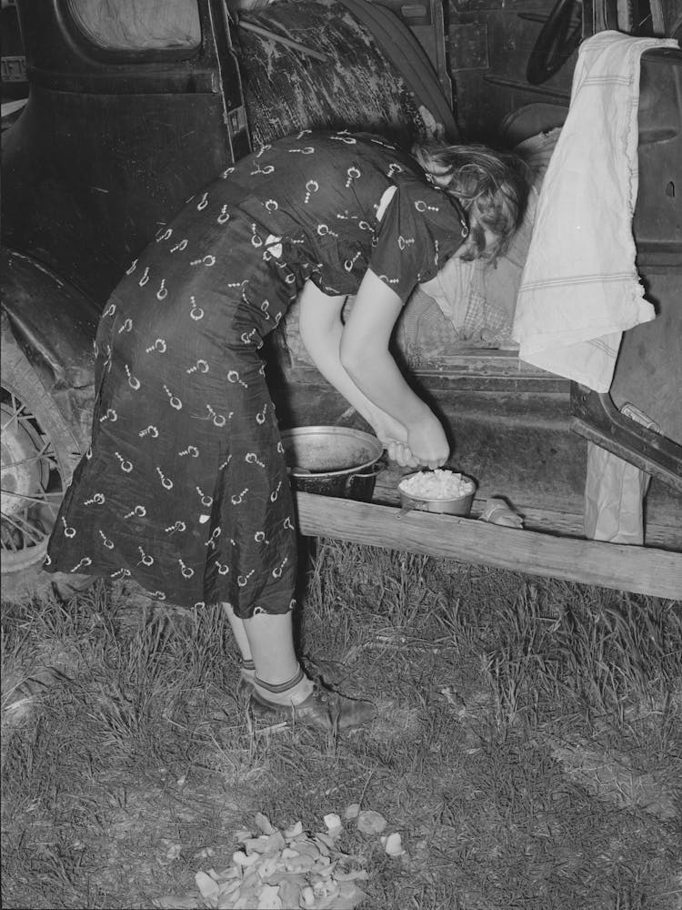Untitled Photo, Possibly Related To Migrant Woman Peeling Potatoes On Running Board Of Car While Camped Ne