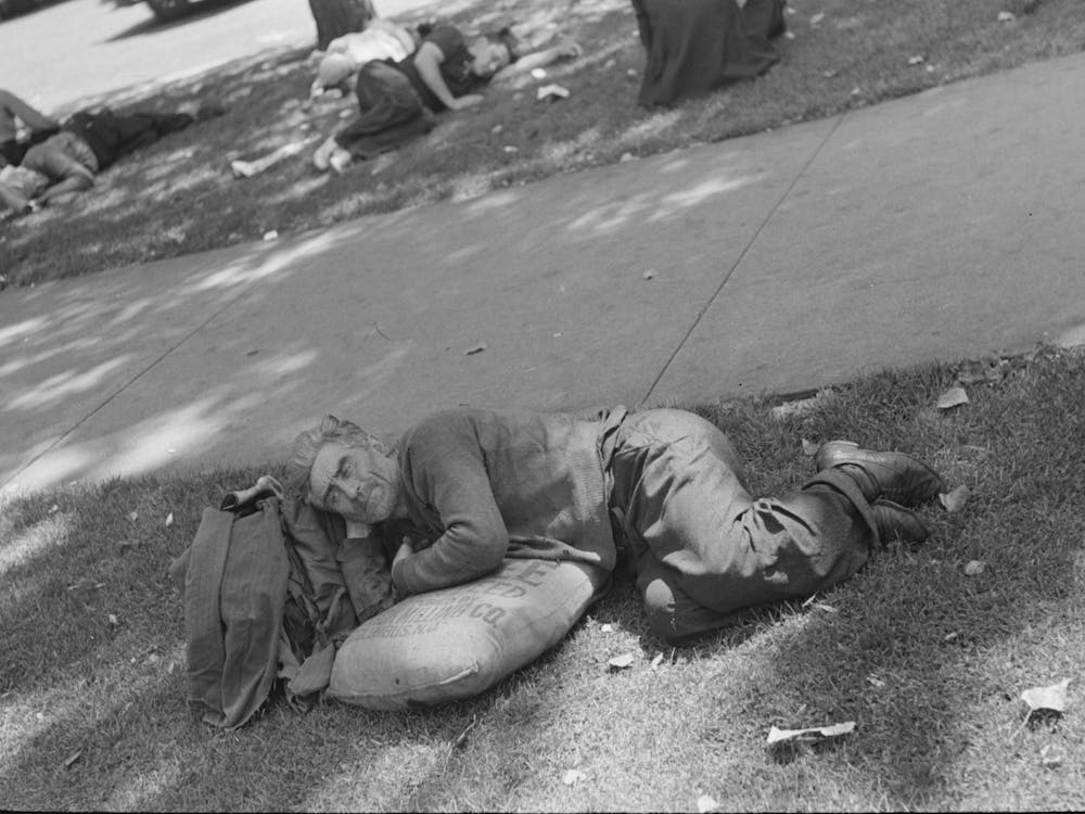 Man Resting In Park On Sack Of Scratch Seed, Minneapolis, Minnesota By Russell Lee