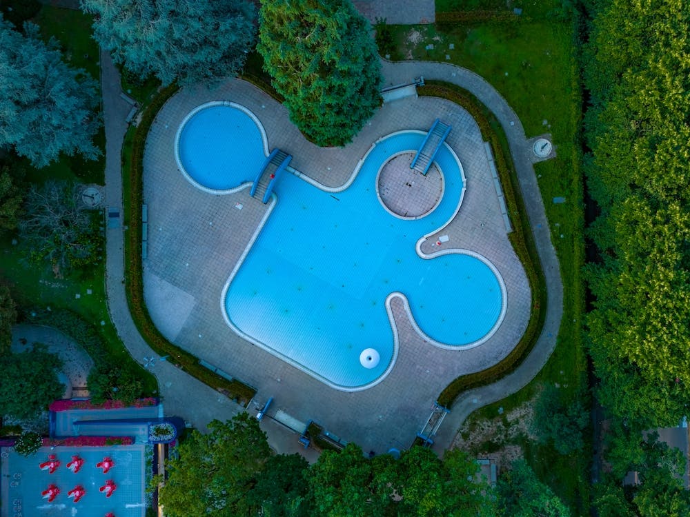 Italy, Milan, San Donato Milanese Aerial view of swimming pool. Beautiful pool ready to holiday tourists.