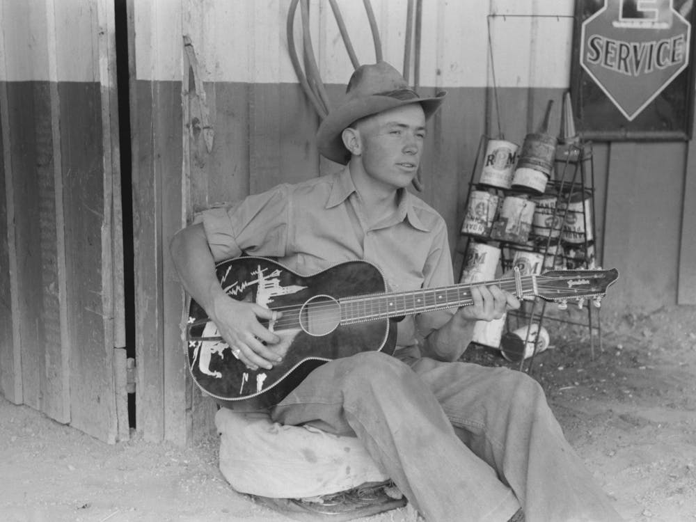 Untitled Photo, Possibly Related To Farm Boy Playing Guitar In Front Of The Filling Station And Garage, Pie Town, Ne