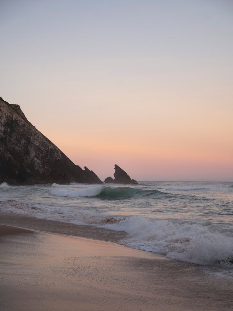 Soft colors at sunrise at Praia da Adraga in Portugal, Europe. Pastel summer travel photography by Christa Stroo Photography