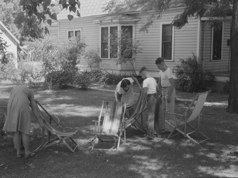 Caldwell, Idaho, Putting The Deck Chairs Out On The Shady Lawn By Russell Lee