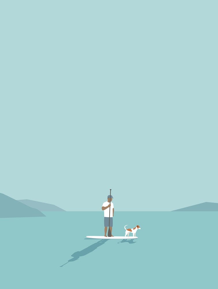 Paddleboarder Et Son Chien