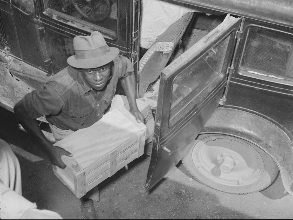 Worker Unloading Crate Of Strawberries At Loading Point,Hammond, Louisiana By Russell Lee