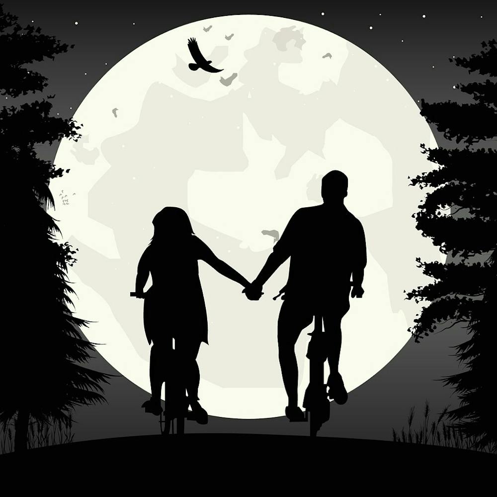 Couple Riding Bikes In The Moonlight