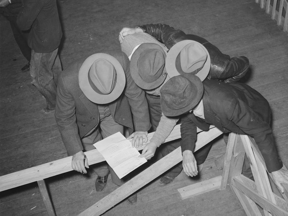 Buyers At Strawberry Auction Studying List Of Car Lots To Be Auctioned, Hammond, Louisiana By Russell Lee