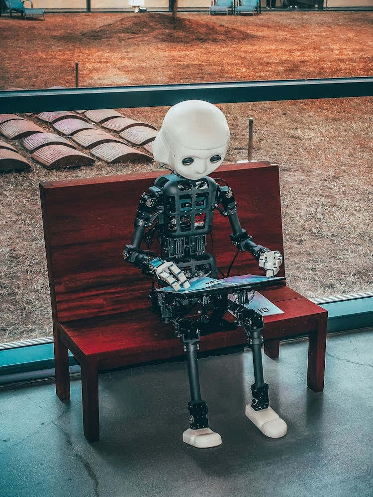 Robot Sitting On A Bench