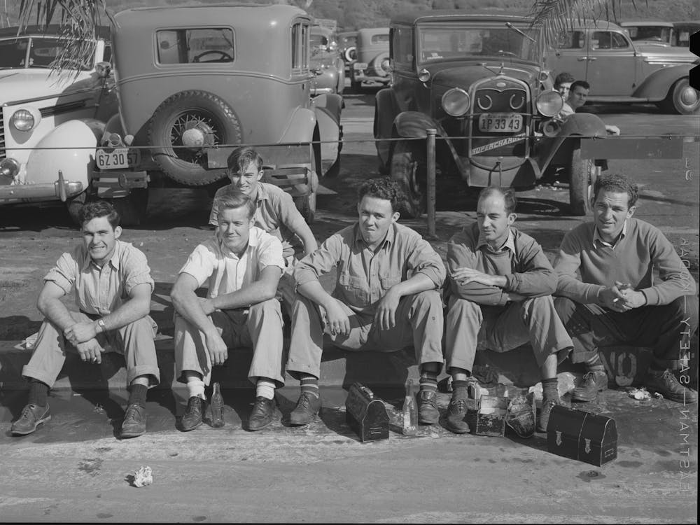 Workers Eating Lunch On Curb Across The Street From The Consolidated Airplane Factory,San Diego, California By Russ