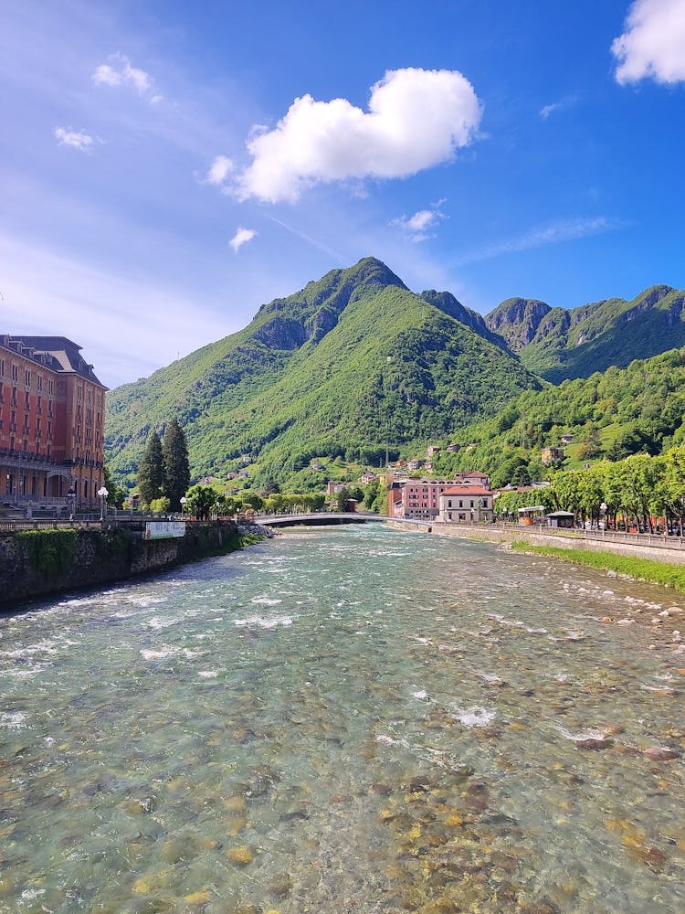 San Pellegrino terme rover from a bridge beautiful mountain in the background green mountain and a river clean water