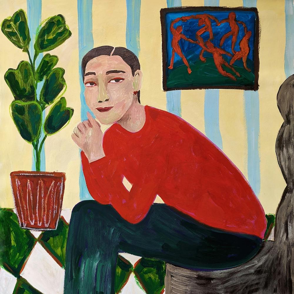 A woman with a plant in a pot on a painting by Matisse in the background