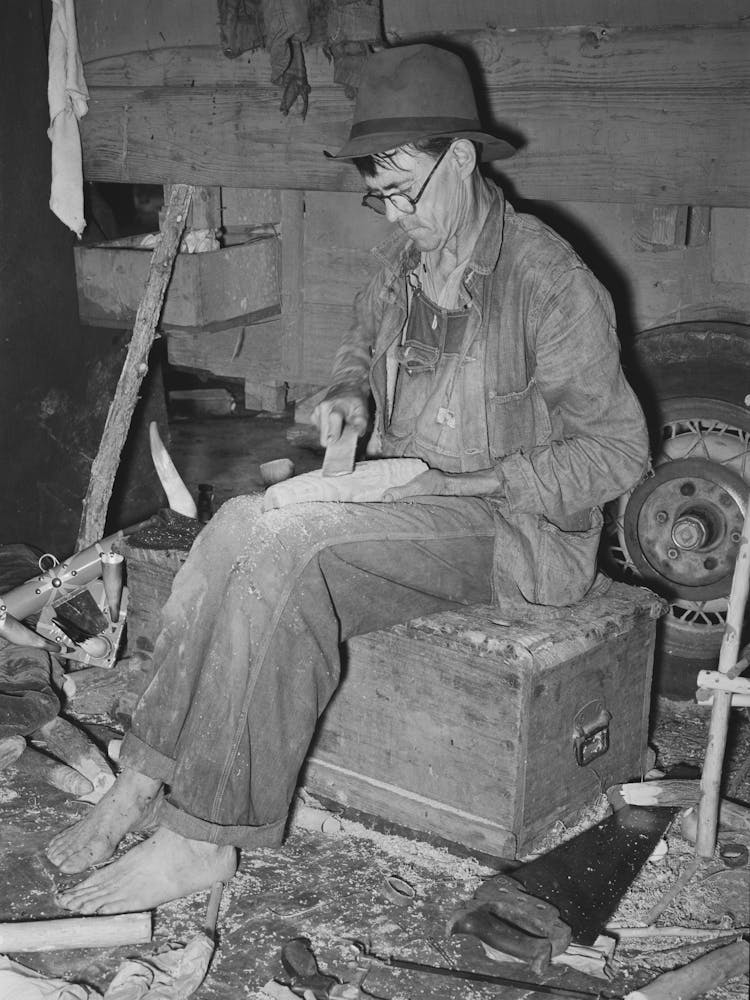 Migrant Worker Who Makes Ornaments From Horns He Is Filing Down A Wooden Block To Be Used As Base For Horns