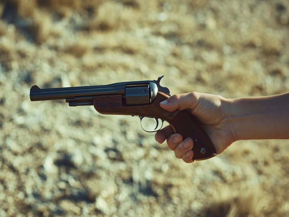 Hand Holding Revolver