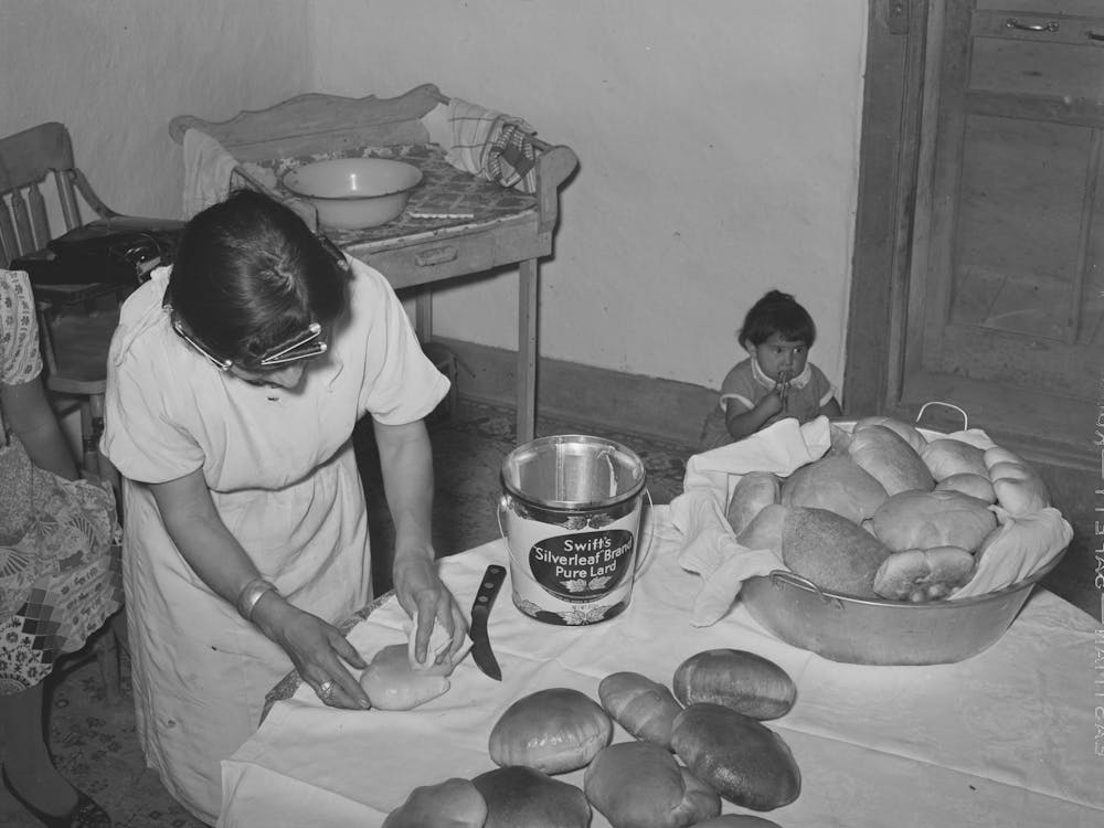 Brushing Lard On Freshly Baked Bread In Spanish American Farm Home Near Taos, New Mexico By Russell Lee