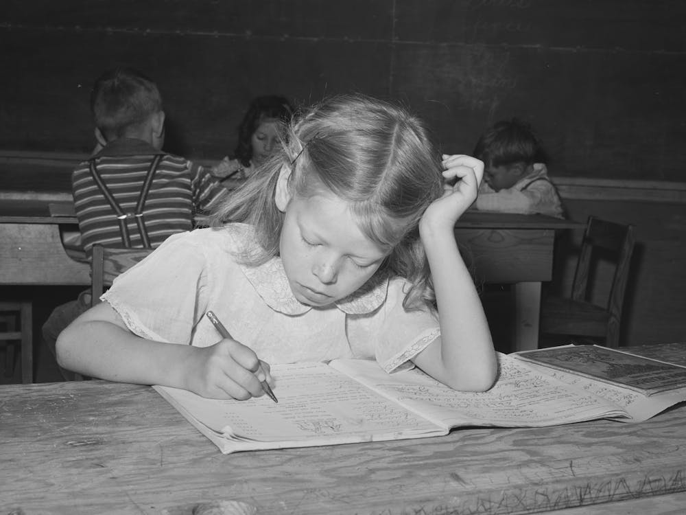 Schoolgirl At The Fsa (Farm Security Administration) Farm Workers Camp, Caldwell, Idaho, Several Family Units Of