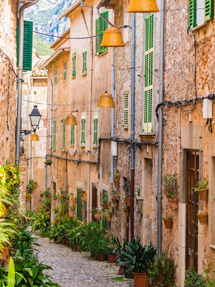 Mallorca Spain. Beautiful view of idyllic street in Valldemossa village on Mallorca island, Spain. Experience the charm and beauty of Valldemossa village on Mallorca island with its idyllic streets and picturesque buildings.