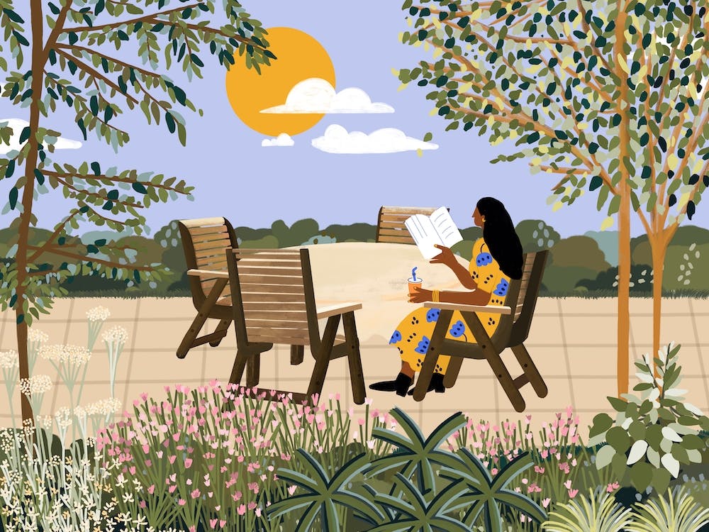 Girl Reading Book In Garden