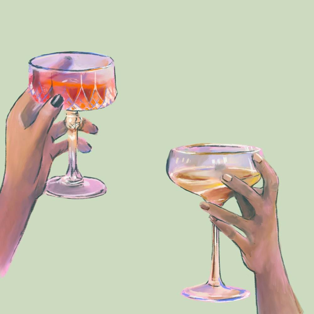 Two Women Holding Glasses Of Wine