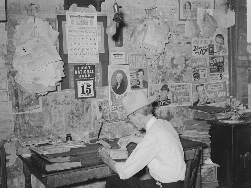 Small Grocery Store Owner Surrounded By Bills, San Augustine, Texas By Russell Lee