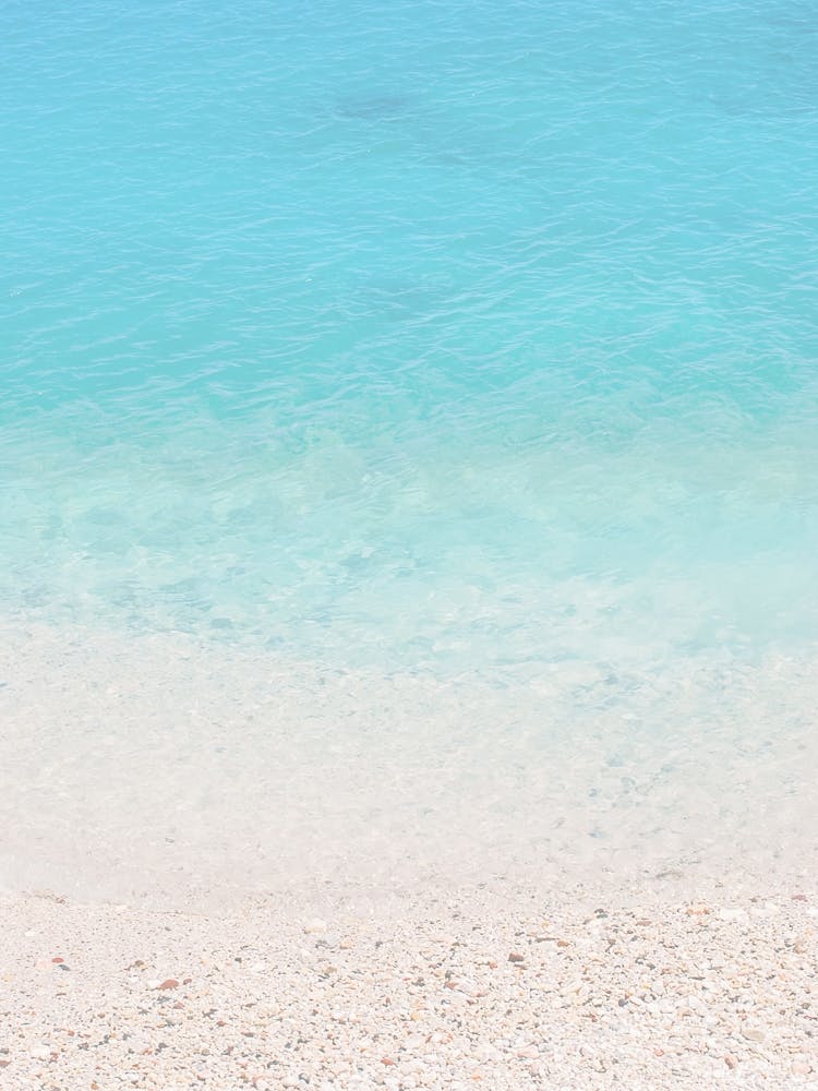 Milos, Greece I Minimalist photography of turquoise water on Mediterranean Sea on a paradise beach with the pastel aesthetic of summer vacations on the French Riviera or in the Caribbean islands