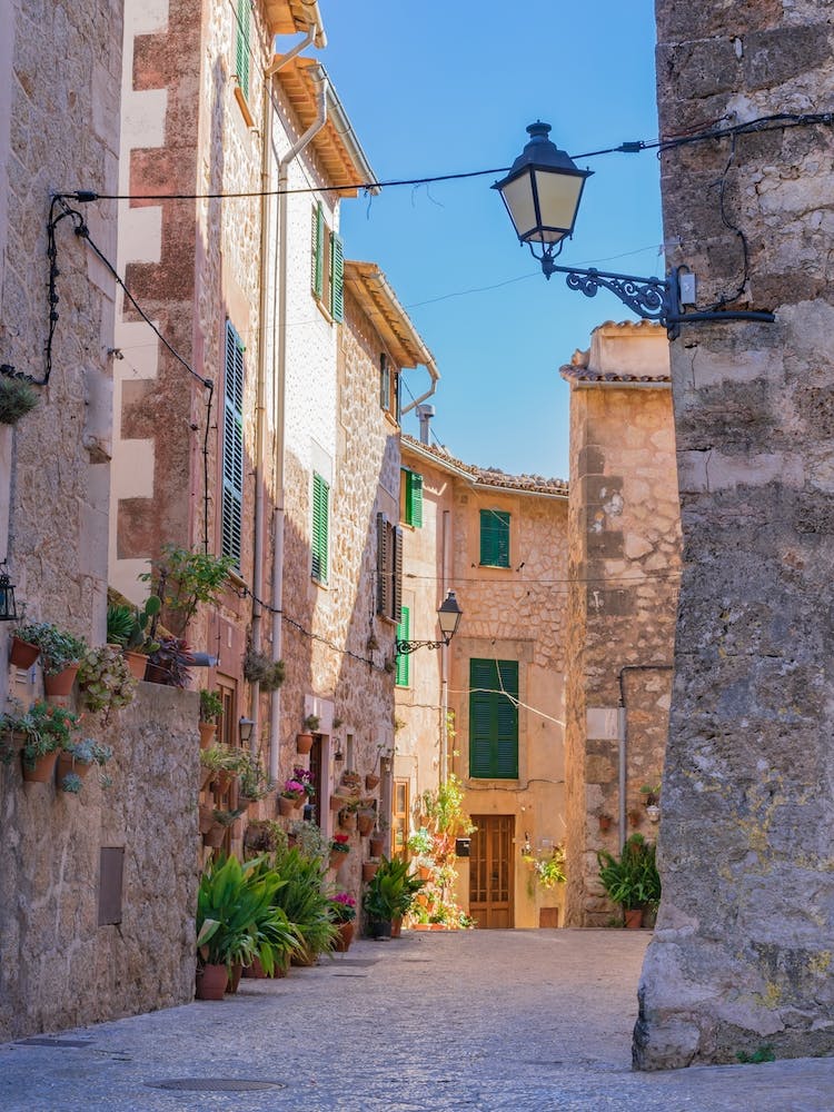 Romantic street in the old village of Valldemossa on Mallorca, Spain Balearic islands. Lose yourself in the idyllic old village of Valldemossa on Mallorca, Spain Balearic islands. This romantic street is a famous landmark that depicts the rich history and