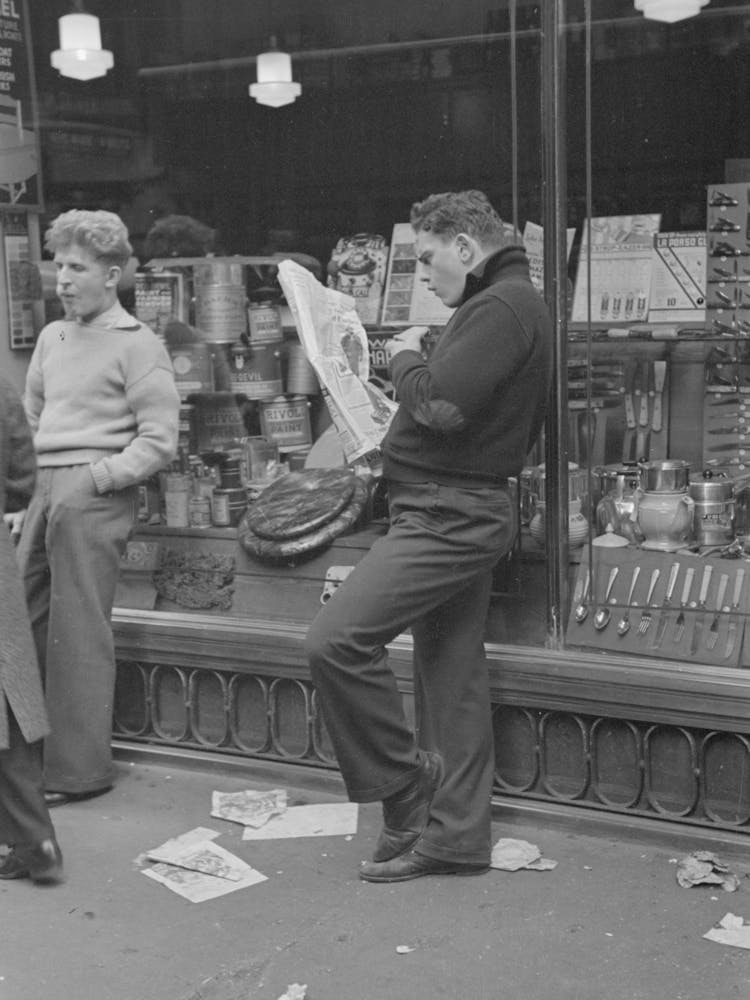 Street Scene On 38th Street Near 7th Avenue, New York City, Teenager Reading Newspaper By Russell Lee
