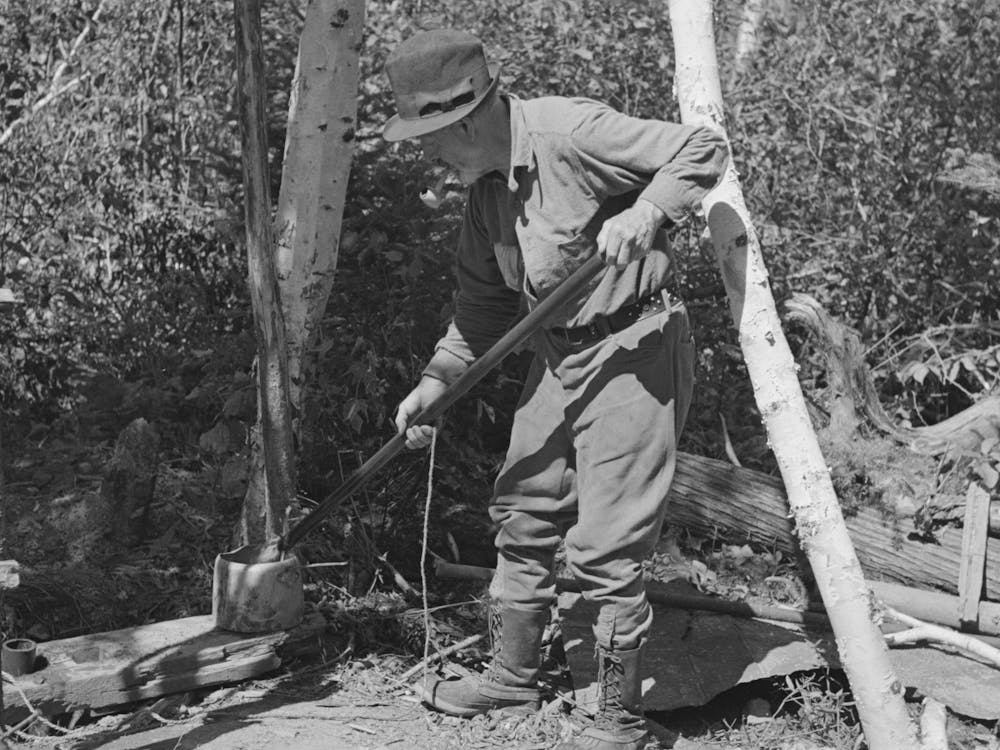 William Besson Removing The Iron Pipe Drill From Casing Near Winton, Minnesota By Russell Lee