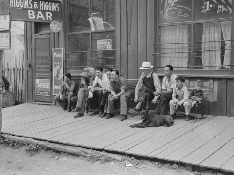 Crowd Of Men Sitting On Board Walk In Front Of Bar At Mogollon, New Mexico, Gold Mining Town By Russell Lee