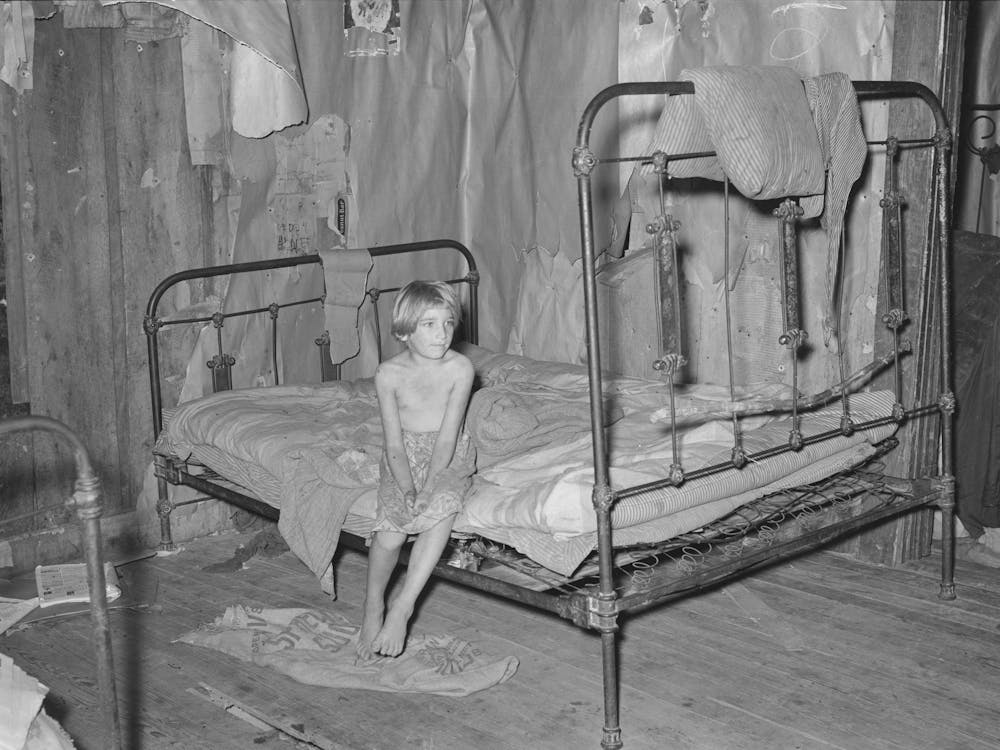 Daughter Of Agricultural Day Laborer In Bedroom Of Home In Mcintosh County, Oklahoma By Russell Lee