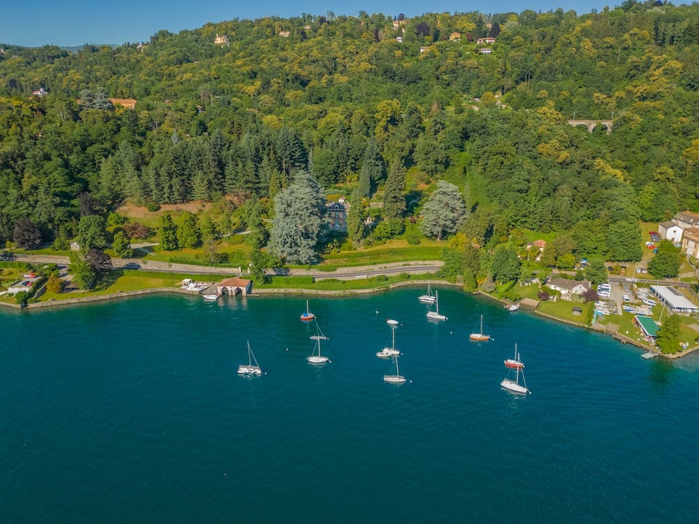 Yachts and boats on the lake. Summer sunny day in Italy. Aerial photography.