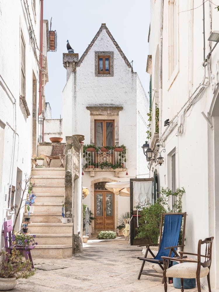 Alleyway With White Houses And Plants In Puglia, Italy