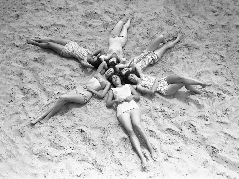 Women Making a Star in the Sand at Beach, Vintage Black and White Old Photo