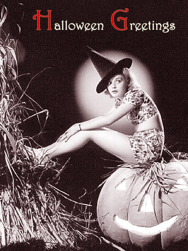 Pin Up Girl Posing On A Big Pumpkin With Big Black Witch Hat