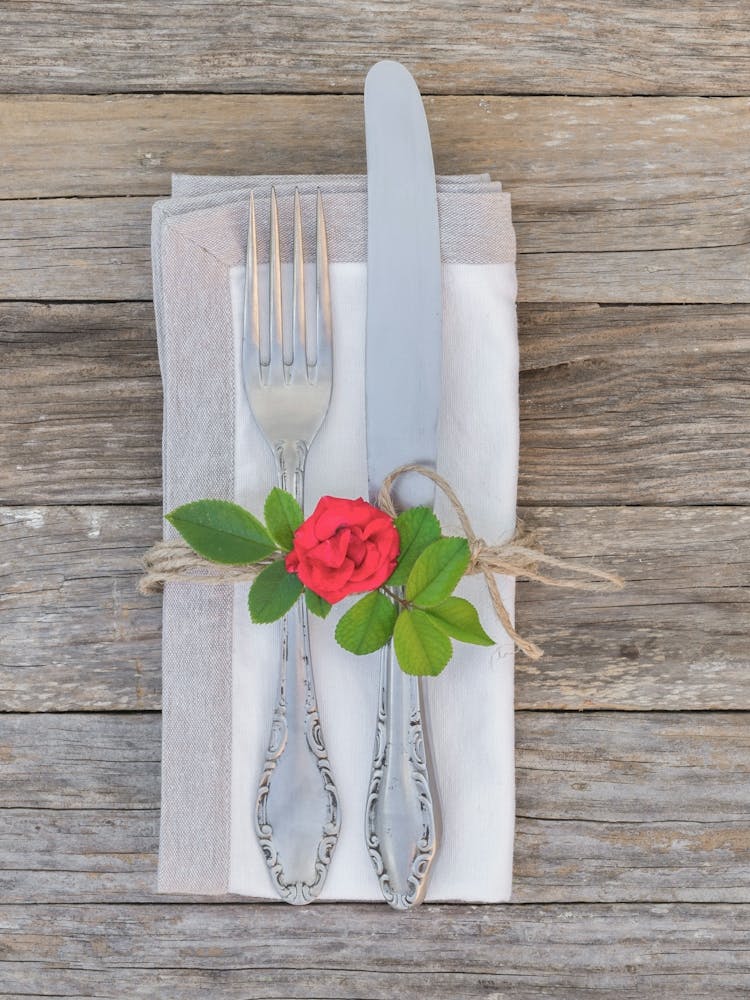 Table Setting With Silverware and rose