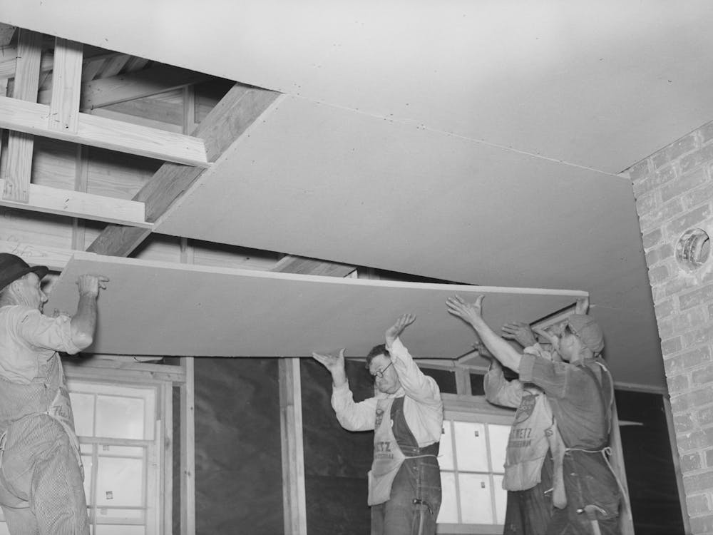 Southeast Missouri Project Field, House Erection, Nailing On Finished Ceiling Of 4 X 7 Insultation Board By Russell Lee