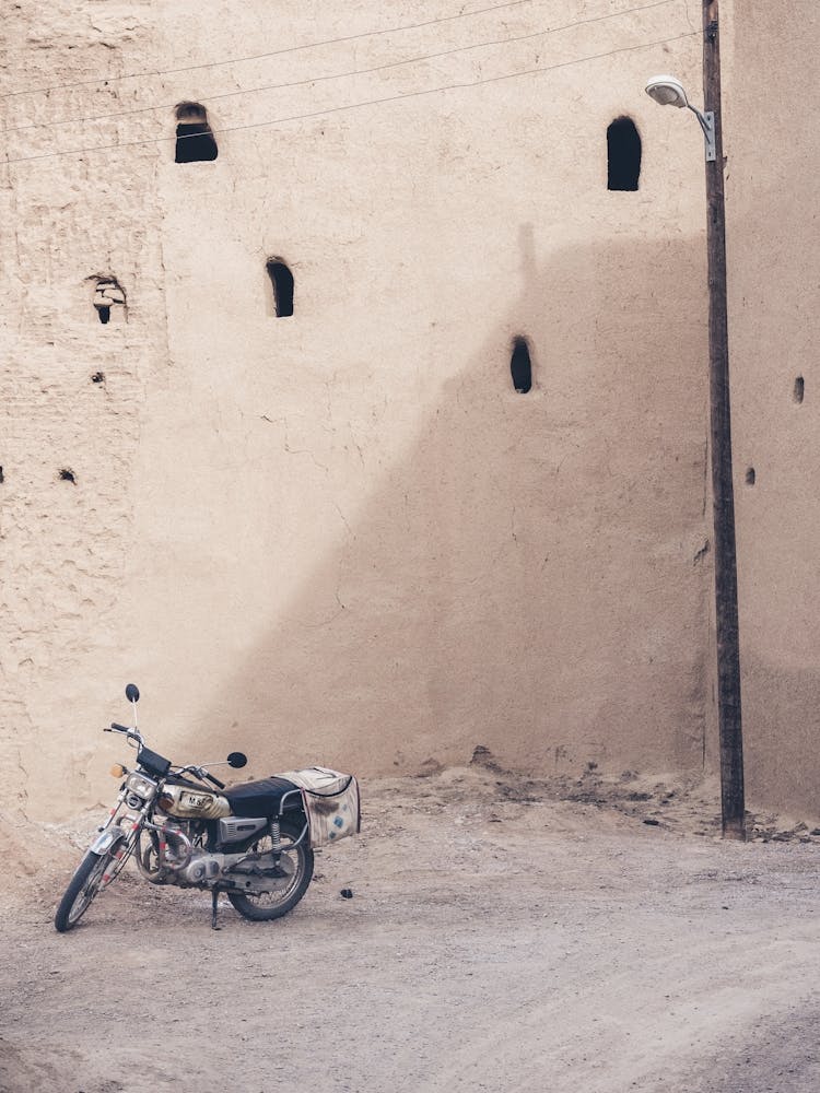 Motorcycle In A Desert Village