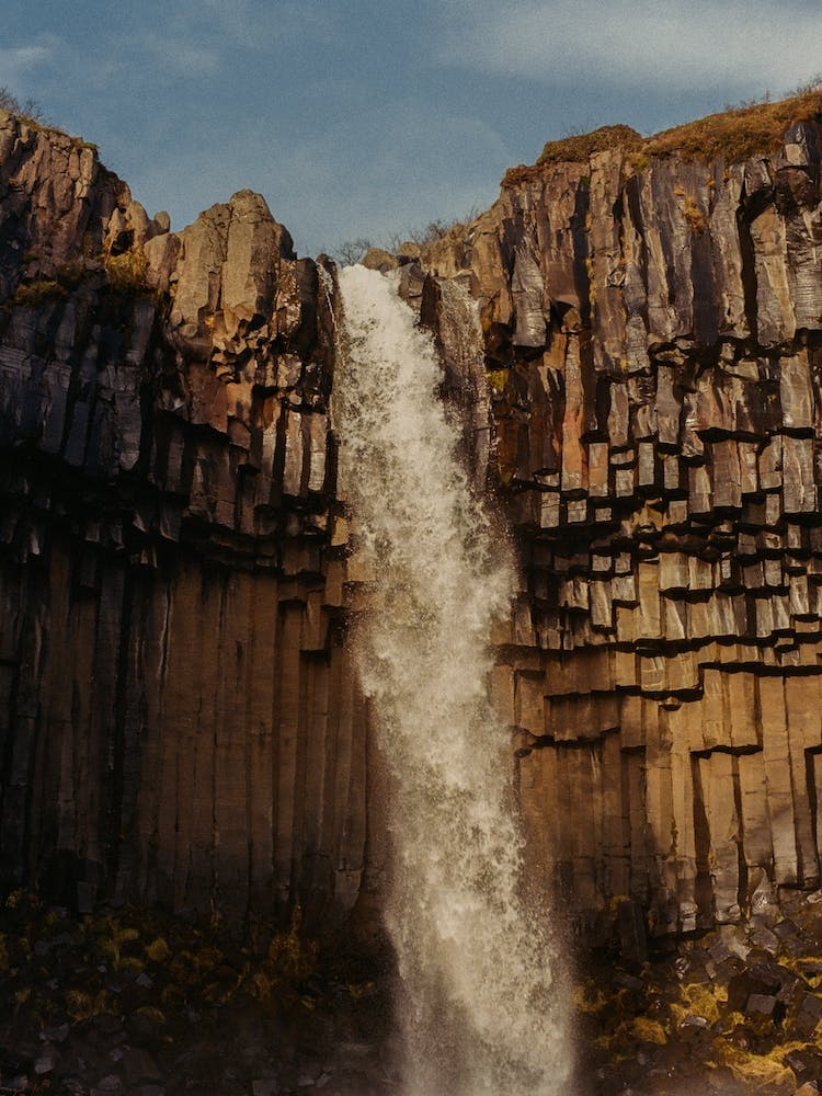 Icelandic Waterfall In Orange Sunset