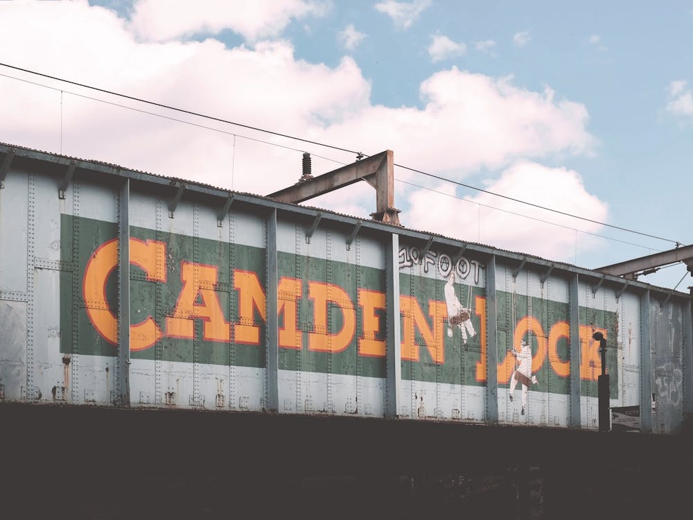 London, England I Camden Town industrial bridge photography to the vibrant urban atmosphere of famous district to the retro vintage aesthetic architecture of urban street cityscape letters mural street art