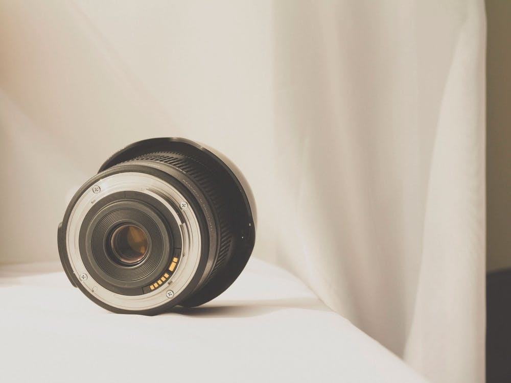 Black Camera Zoom Lens On White Cloth 05