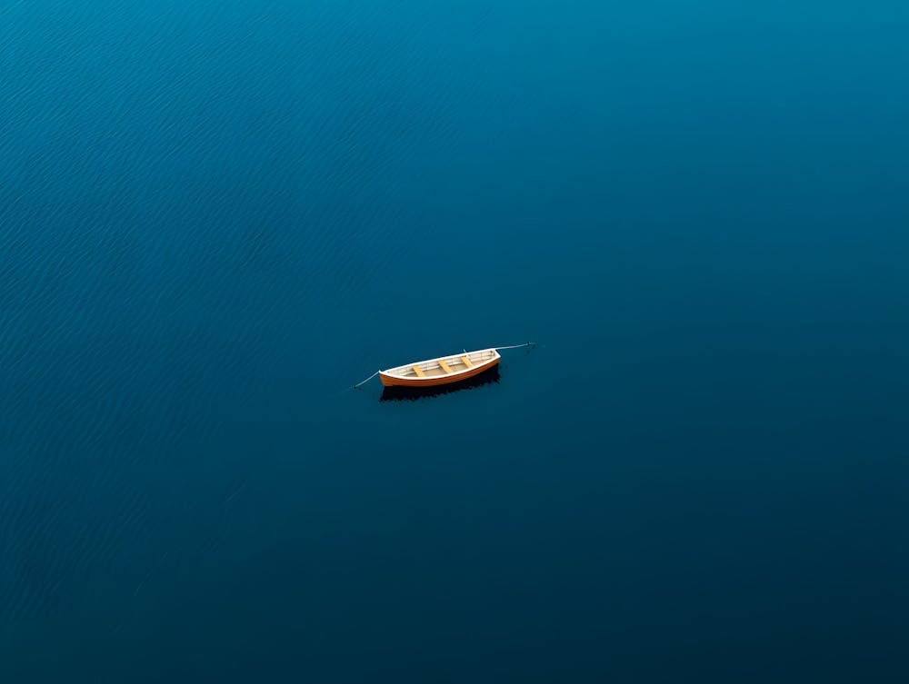 Small Boat In Blue Water