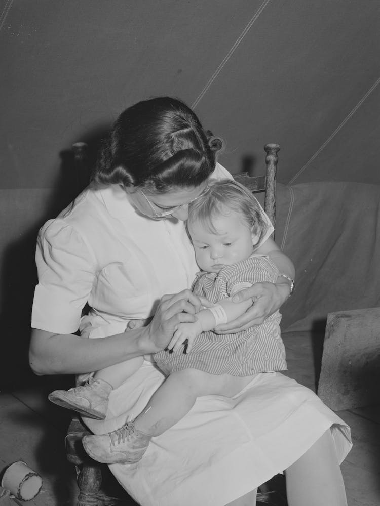 Nurse Looks At Cut On Baby S Arm At The Fsa (Farm Security Administration) Migratory Labor Camp Mobile Unit