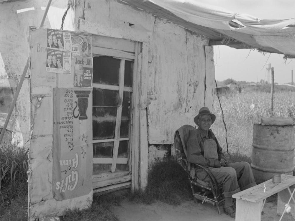 Resident Of Tin Town Sitting In Front Of His Shack Home, Caruthersville, Missouri By Russell Lee