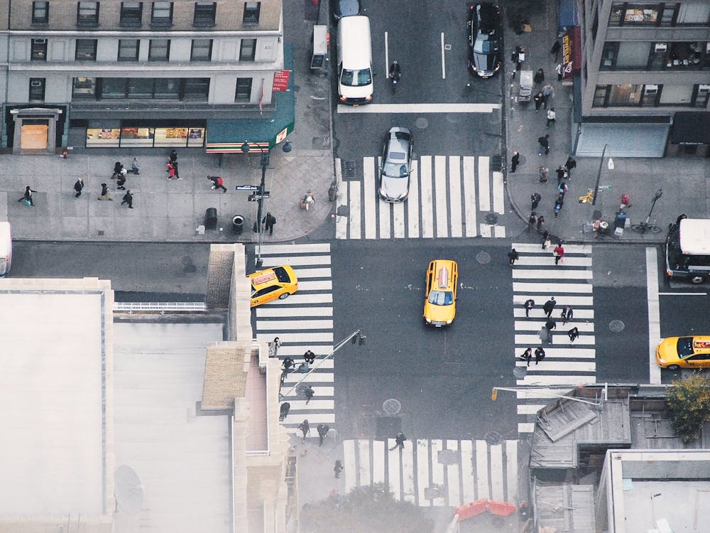New York, USA I Miniature black and white aerial view photography from building rooftop Rockefeller center or NYC city skyscraper looks like a video game with its yellow cabs taxi, passerby, cars and architecture