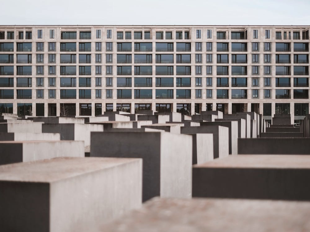 Berlin, Germany I Memorial to the Murdered Jews of Europe in urban city panorama with dark geometric lines and modern soviet architecture photography in a minimalist and powerful berliner perspective