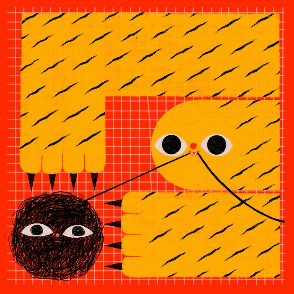 yellow happy tiger plays with woolen ball on checkered red backdrop