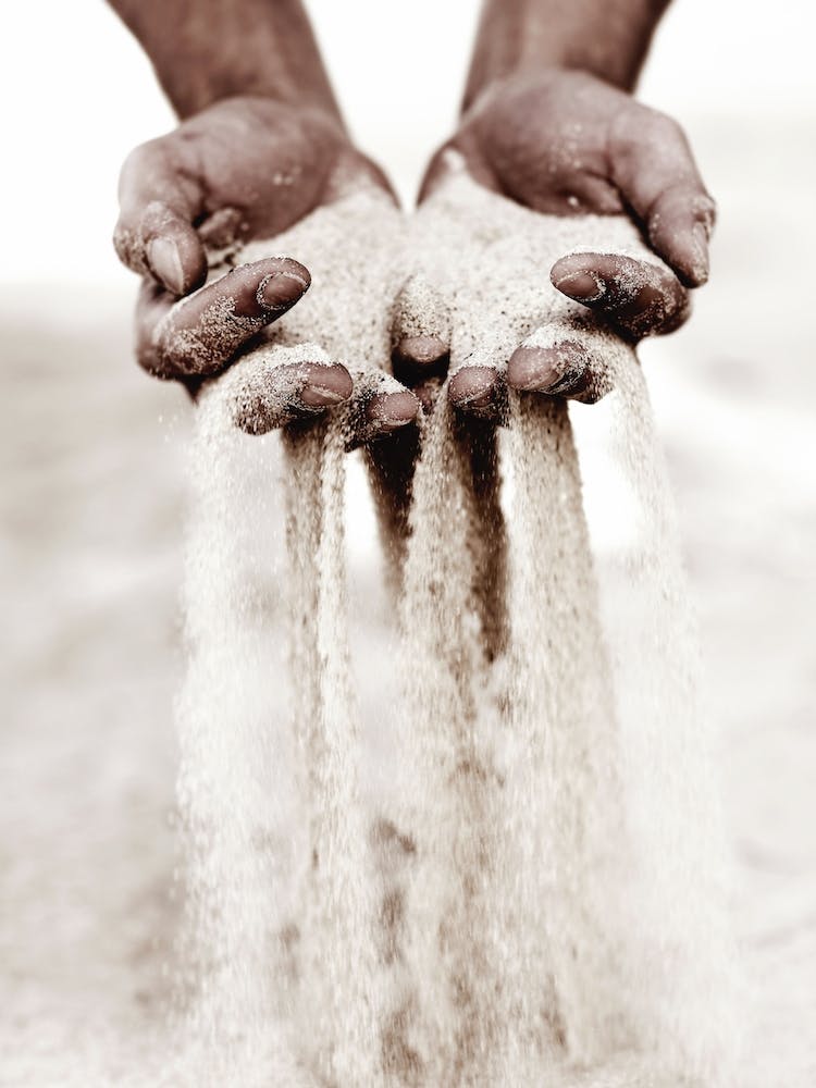 Hands Pouring Sand