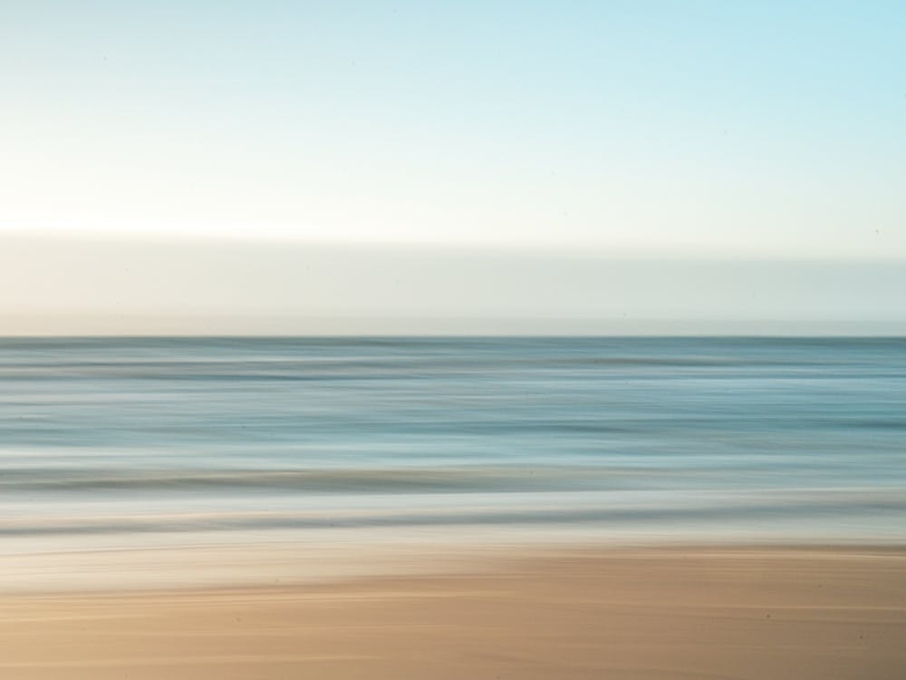 Dreamy long exposure of the ocean - neutral colors and blue waves - abstract nature and travel photography by Christa Stroo
